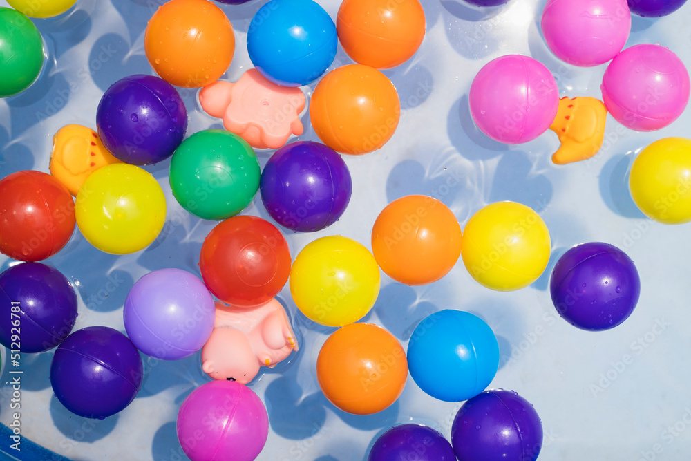 Colorful balls. holiday, children's party, a games room, a box filled with small colored balls. Many colorful plastic balls in a swimming pool. Colorful balls. holiday, children's party, a games room, a box filled with small colored balls. Many colorful plastic balls in a swimming pool.