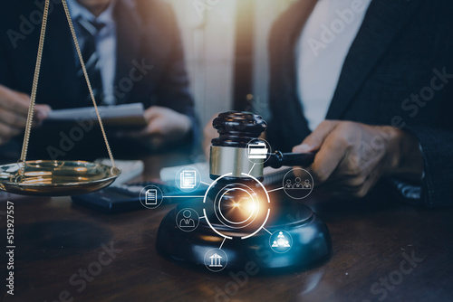 Business and lawyers discussing contract papers with brass scale on desk in office. Law, legal services, advice, justice and law concept picture with film grain effect