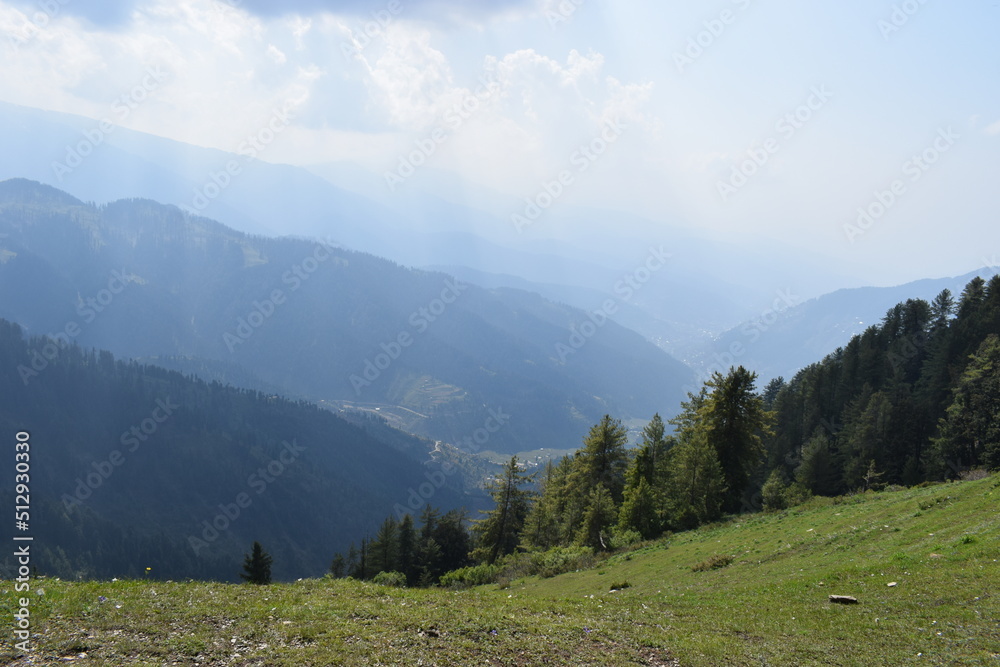 Landscape view of Mountain Valley green meadows and cloud