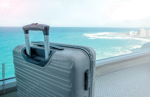 Concept for tropical travel. Suitcase on balcony with ocean view in luxury beach hotel.Copy space © vasanty