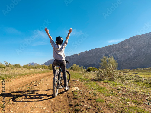 young boy riding mountain bike in countryside