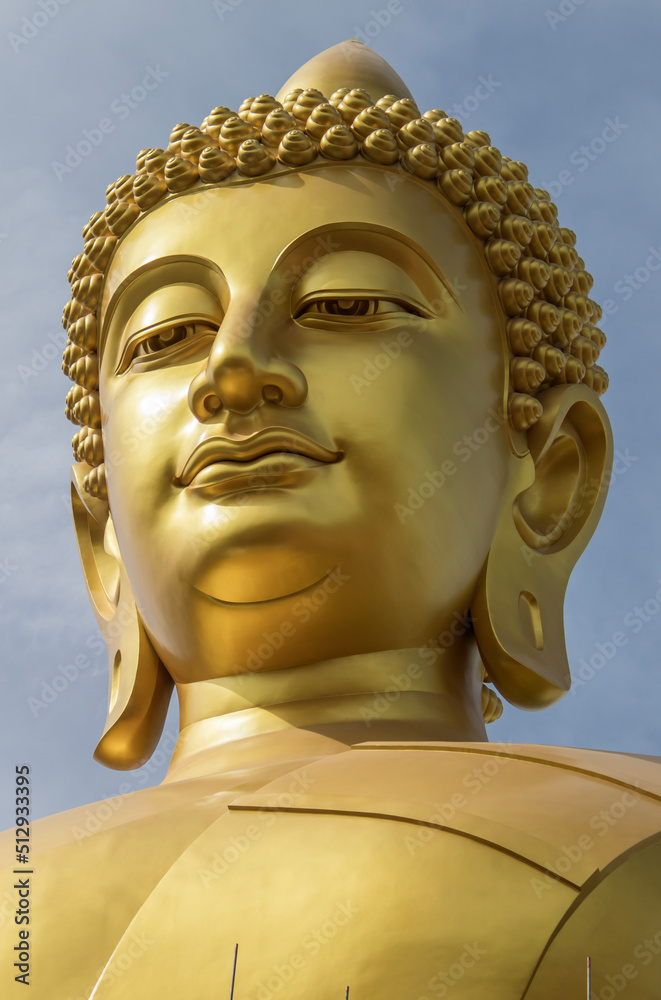 Phasi Charoen district,Bangkok,Thailand on May29,2020:Details of the face of Phra Buddha Dhammakaya Thepmongkhon,the large outdoor golden Buddha image at Wat Paknam Phasi Charoen.
