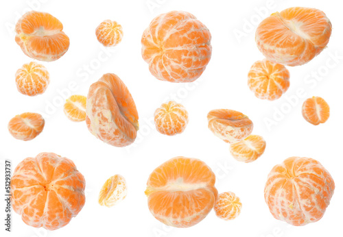Tasty peeled tangerines falling on white background