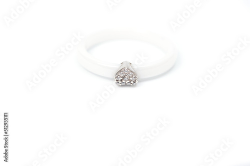 White ceramic ring with a metal heart decorated with rhinestones.