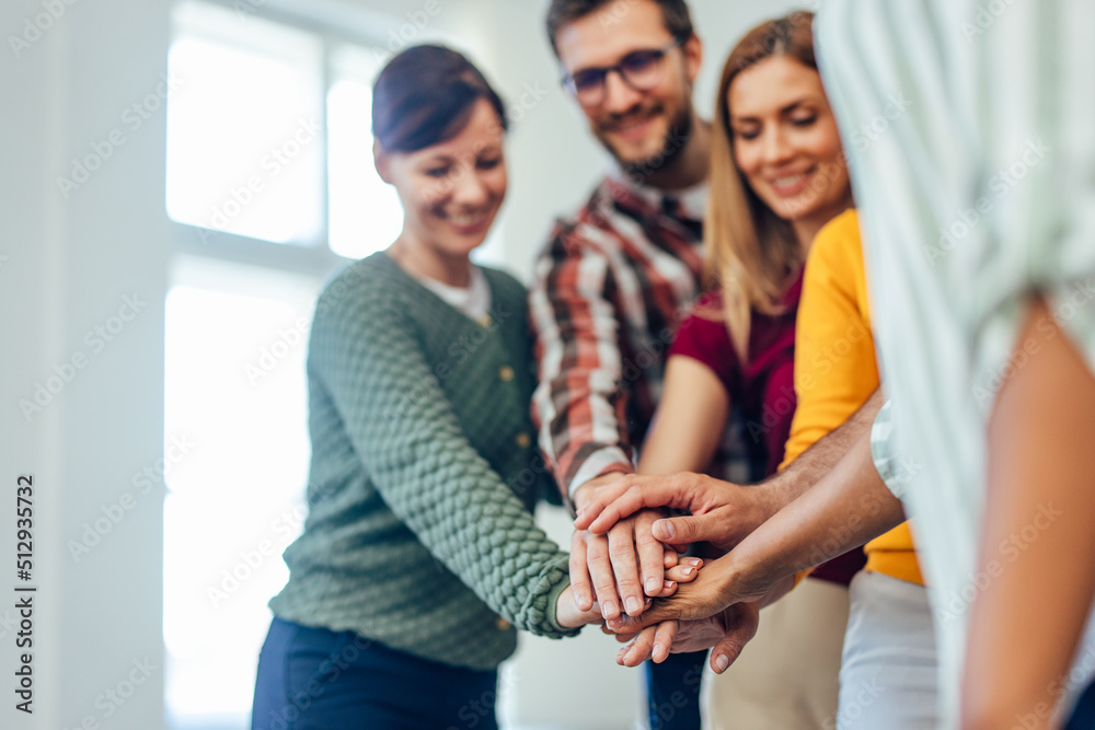 Focus on the people's hands, holding them together in the middle. Focus on the people's hands, holding them together in the middle.