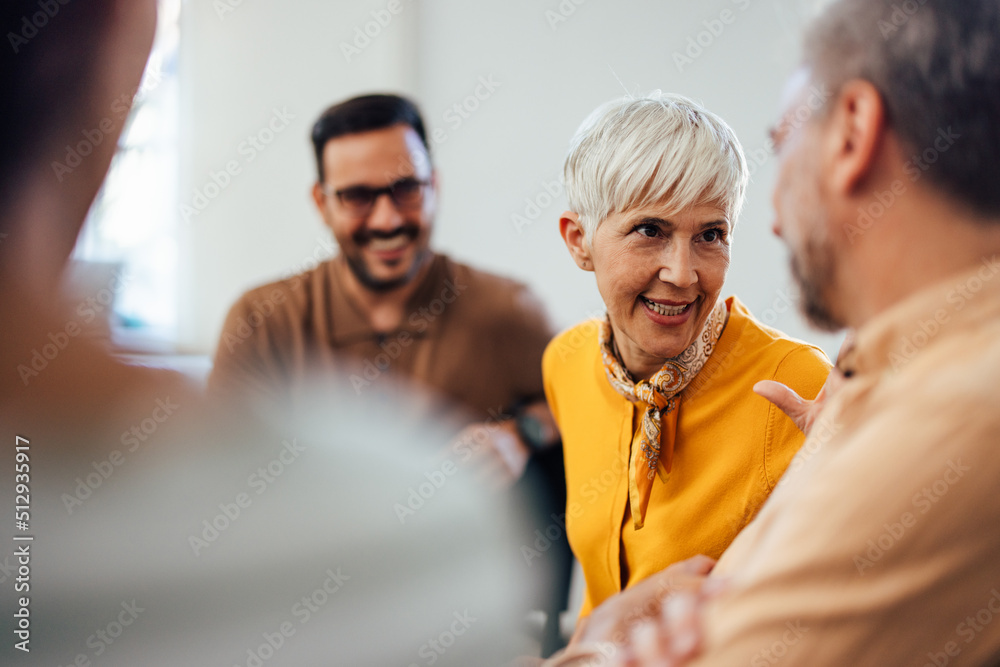 © bnenin - Focused woman, carefully listening and talking to one man during the group therapy. © bnenin - Focused woman, carefully listening and talking to one man during the group therapy.