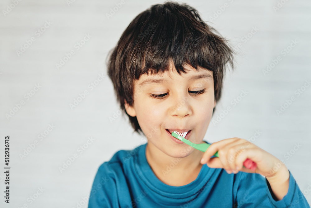 Little boy brushing his teeth on white background. little kid cleans his teeth with toothbrush Little boy brushing his teeth on white background. little kid cleans his teeth with toothbrush