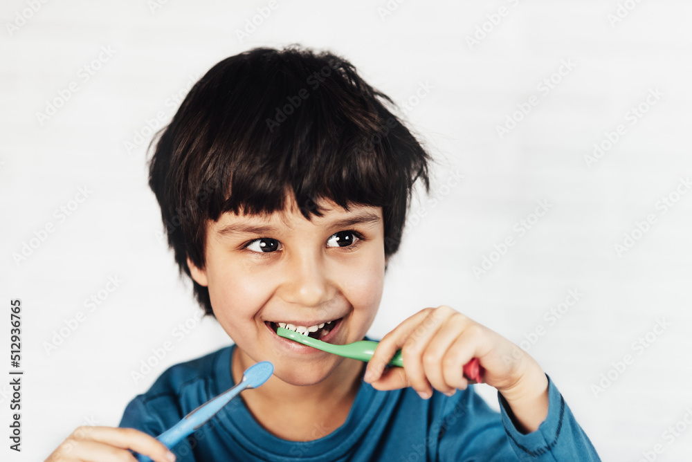 Little boy brushing his teeth on white background. little kid cleans his teeth with toothbrush Little boy brushing his teeth on white background. little kid cleans his teeth with toothbrush