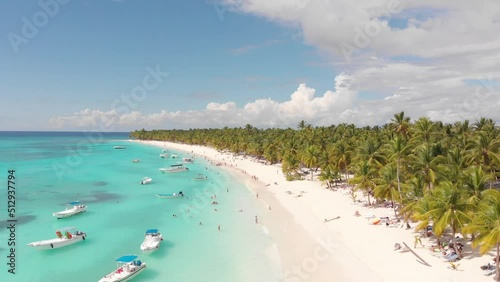 Drone shot of boats on the water close to the paradise shore
