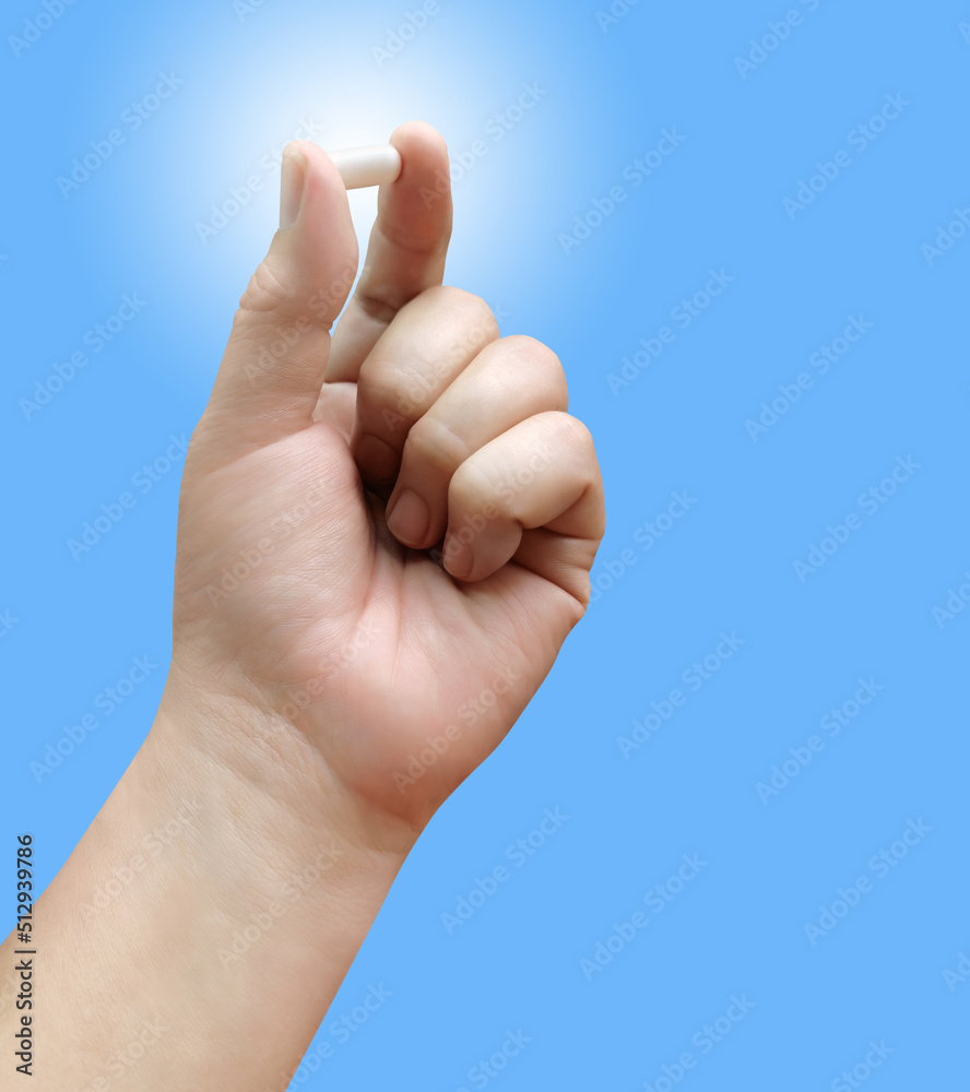 male hand holding pills gesture lonely on a blue background male hand holding pills gesture lonely on a blue background