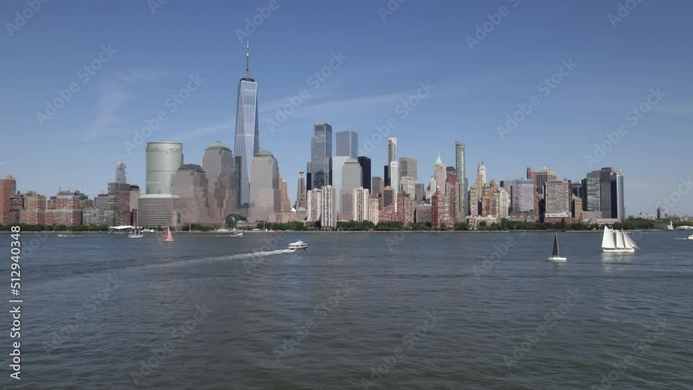 Aerial view over boats on Hudson river, towards the Manhattan skyline, in sunny New York, USA - low, rising, drone shot Aerial view over boats on Hudson river, towards the Manhattan skyline, in sunny New York, USA - low, rising, drone shot