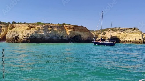 Boat sailing in front of the caves and secret beaches