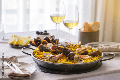 Typical Spanish dish seafood Paella made with prawns, clams and mussels on saffron rice with vegetables/