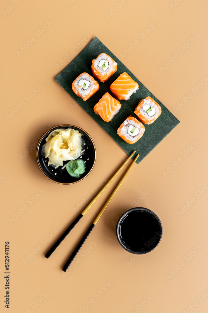 Sushi rolls set with salmon eco served on green papper plate, top view Sushi rolls set with salmon eco served on green papper plate, top view