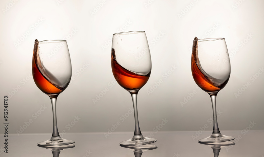 three falling glasses with red wine, motion blur, blur three falling glasses with red wine, motion blur, blur
