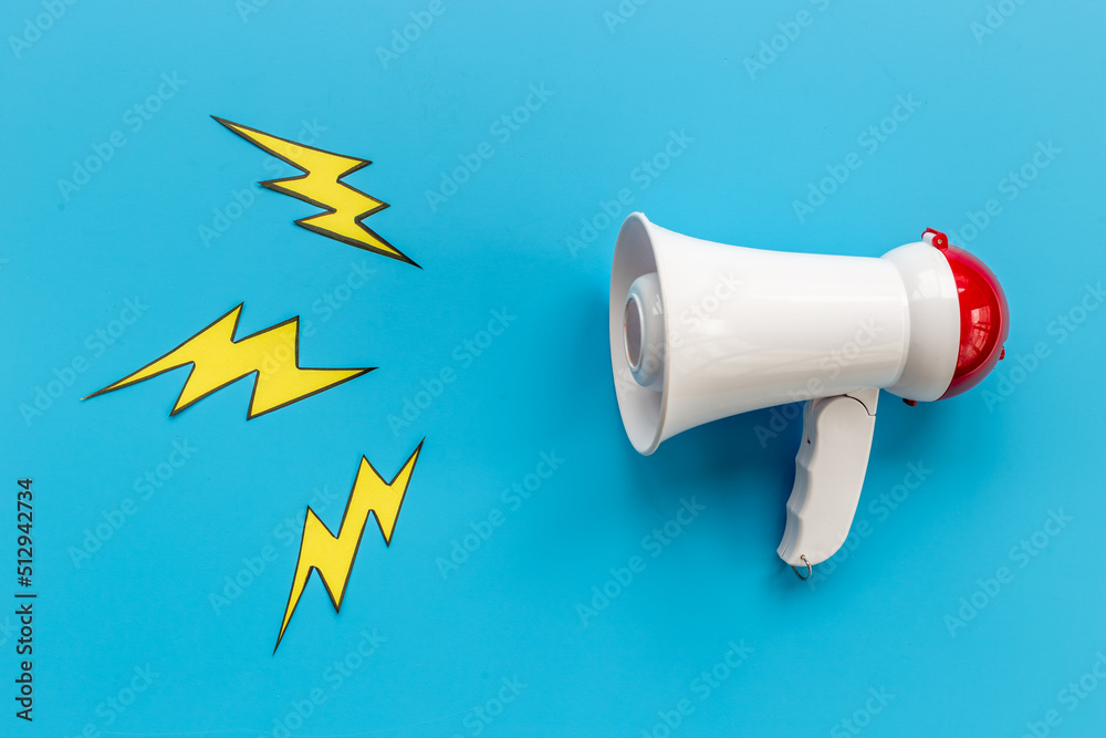 Attention and hot news concept. Megaphone with flying lightning