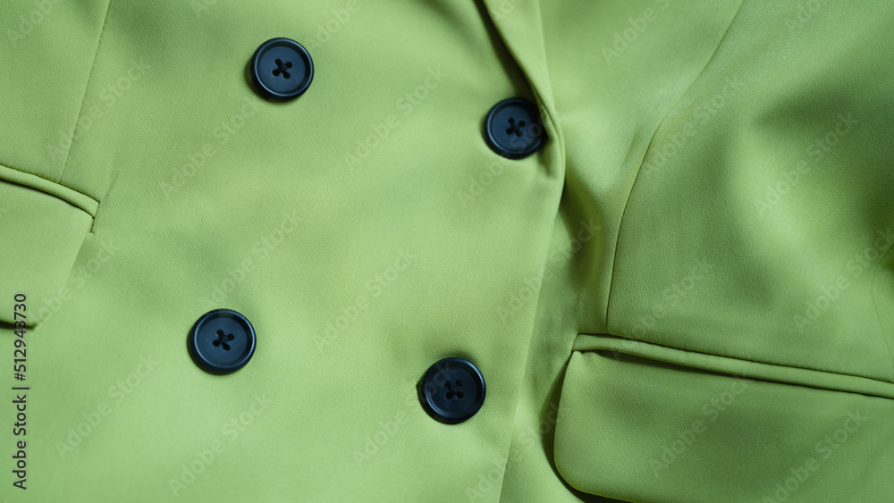 Light green jacket blouse with black buttons closeup