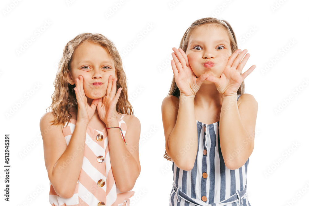 Portrait of two cheerful girls in retro style summer outfit isolated on white background. Concept of art, friendship, hope, youth, fashion Portrait of two cheerful girls in retro style summer outfit isolated on white background. Concept of art, friendship, hope, youth, fashion