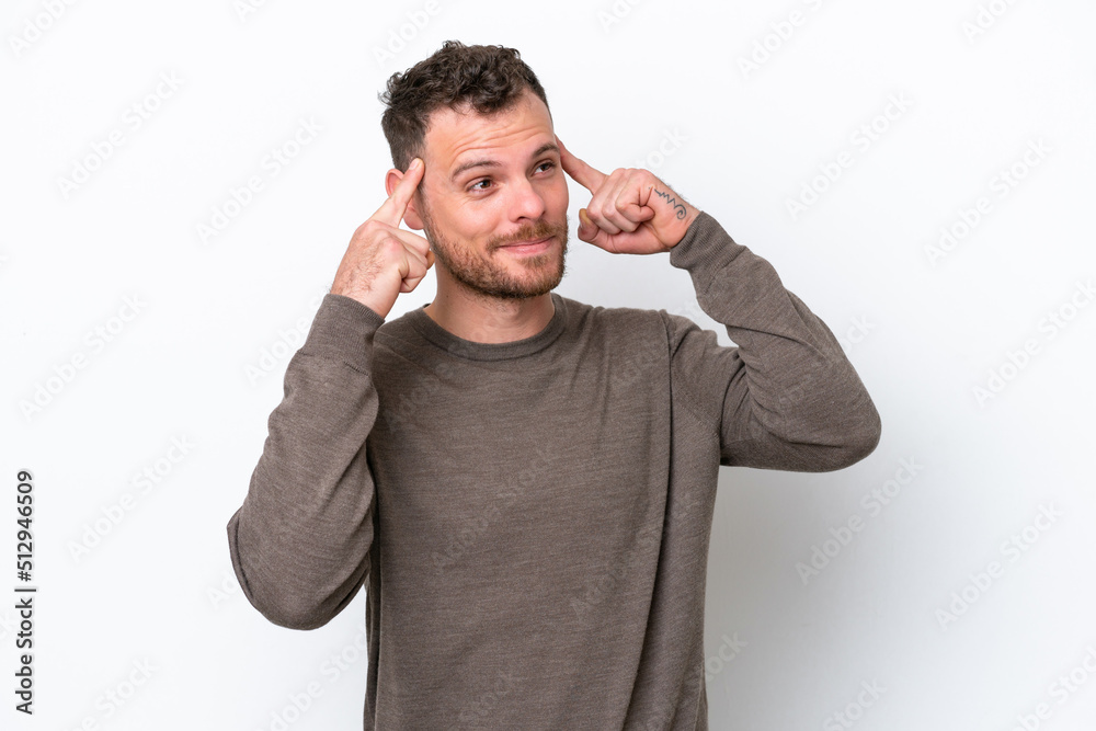 Young Brazilian man isolated on white background having doubts and thinking Young Brazilian man isolated on white background having doubts and thinking