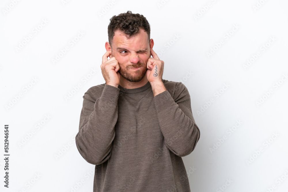 Young Brazilian man isolated on white background frustrated and covering ears Young Brazilian man isolated on white background frustrated and covering ears