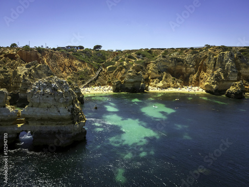 Panoramic view, beach of Camilo Lagos in Algarve, Portugal. Cliff rocks,  and tourist boat on sea and caves at Ponta da Piedade, Algarve region, Portugal. photo