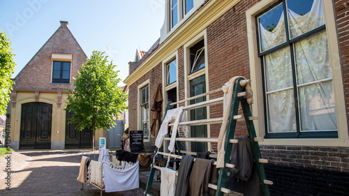 Enkhuizen, Netherlands. June 2022. a street in the Zuiderzee Museum with old fishermen's cottages and drying laundry. photo