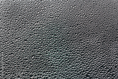 Background photo of water droplets on a glass plate.