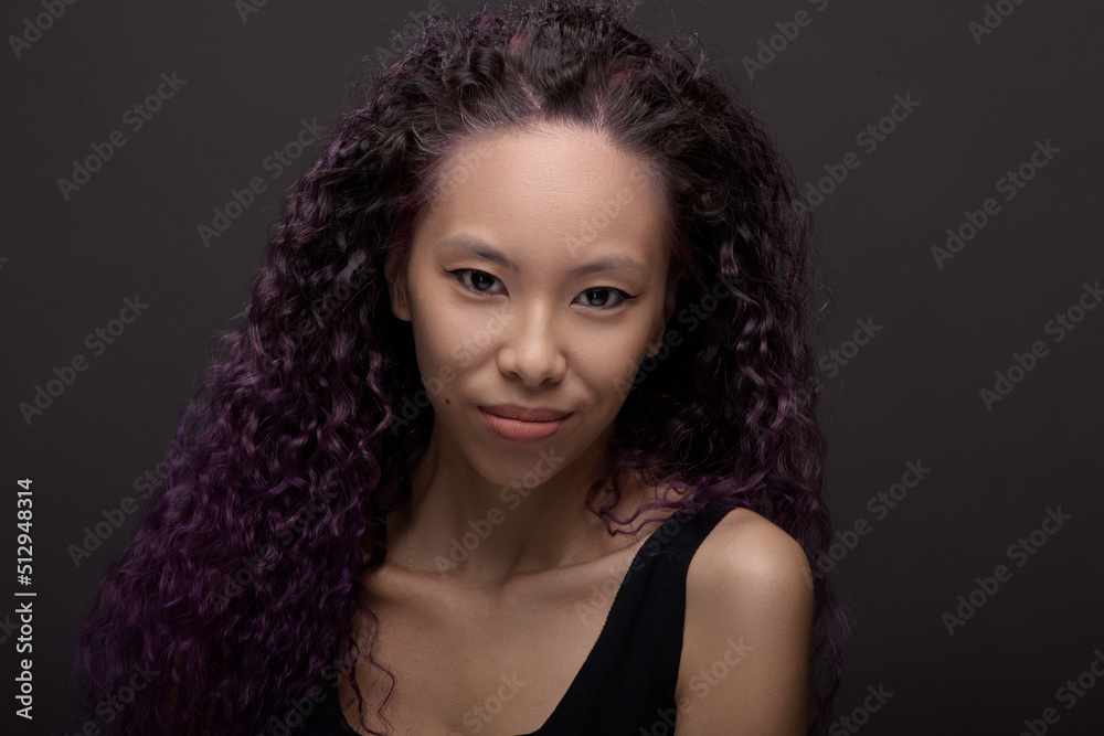 Fototapeta premium Portrait of young asian woman with curly hair
