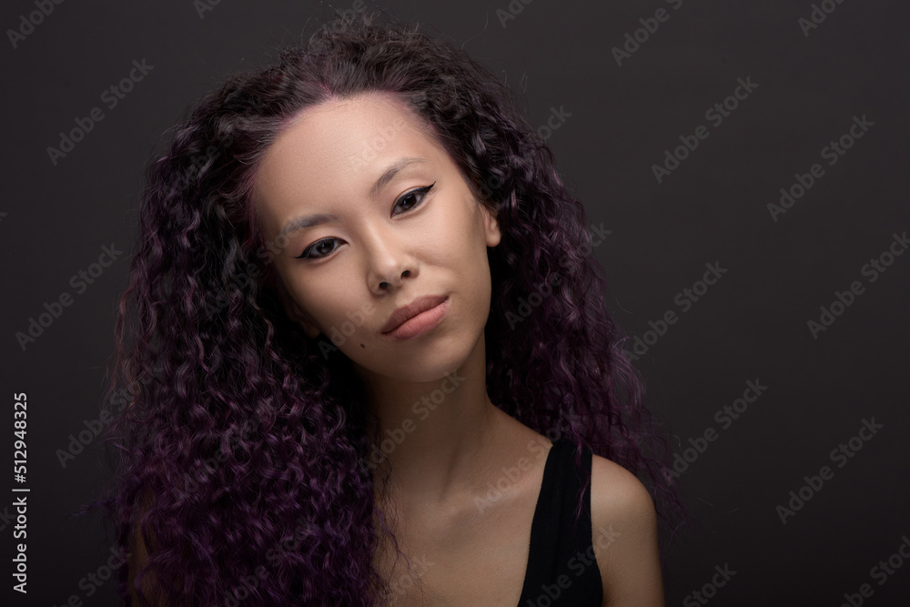 Portrait of young asian woman with curly hair Portrait of young asian woman with curly hair