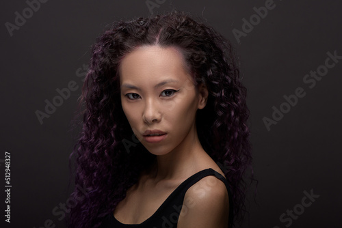 Portrait of young asian woman with curly hair