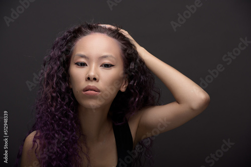 Portrait of young asian woman with curly hair