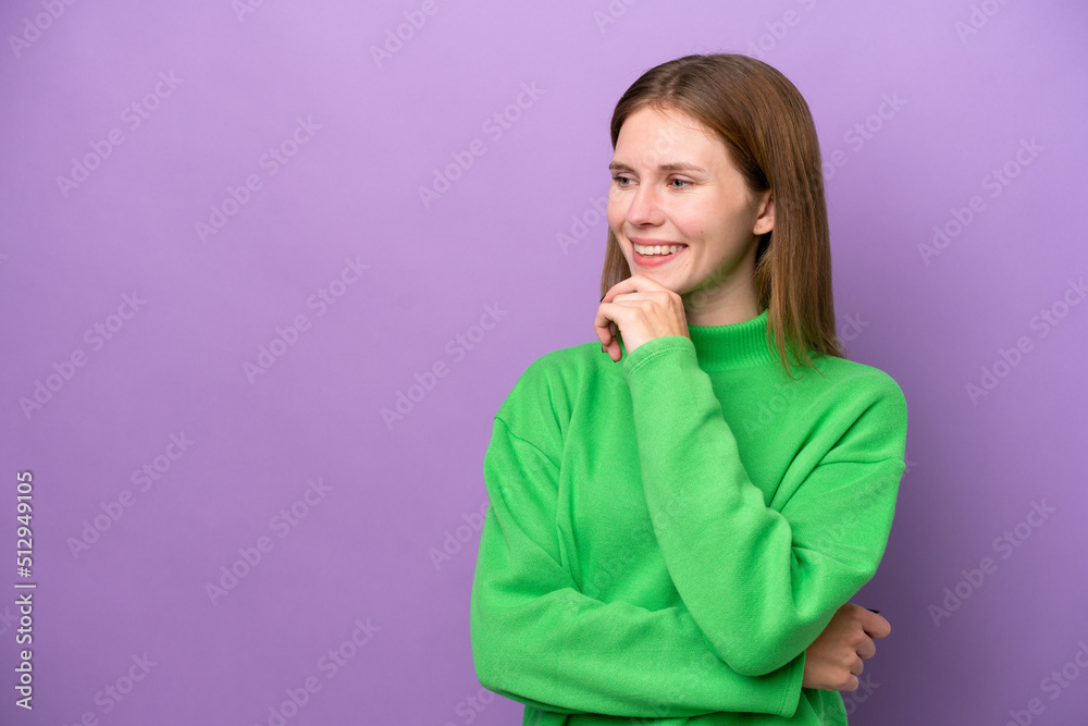 Young English woman isolated on purple background looking to the side and smiling Young English woman isolated on purple background looking to the side and smiling