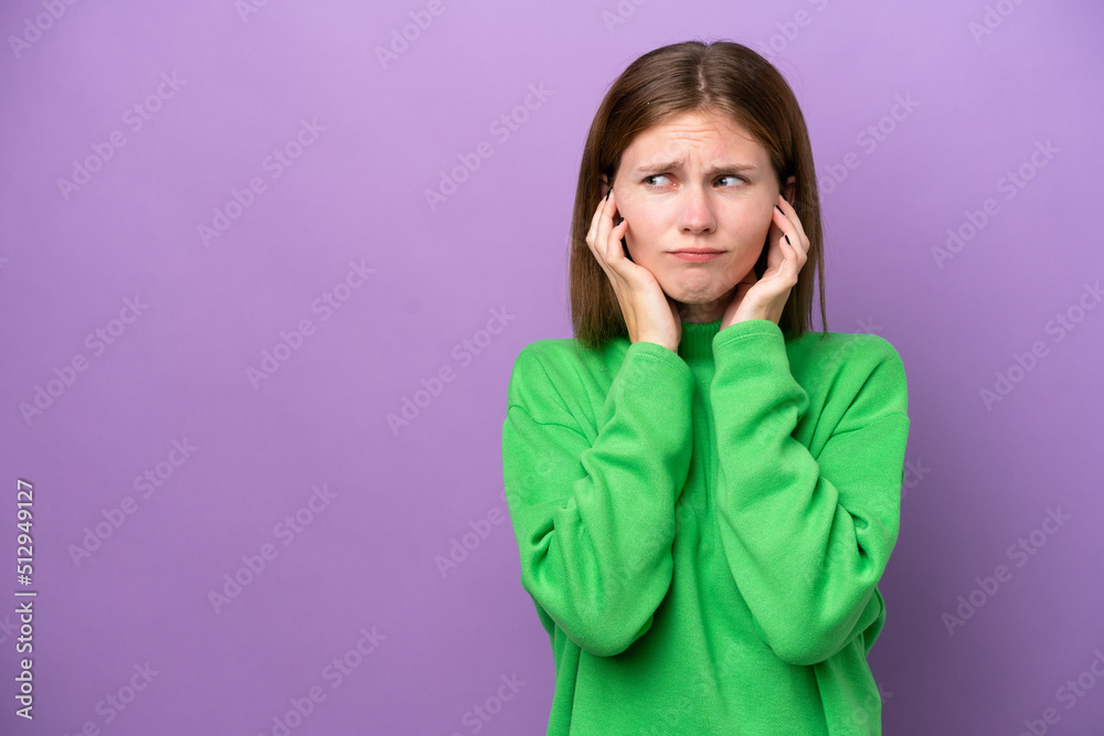 Young English woman isolated on purple background frustrated and covering ears Young English woman isolated on purple background frustrated and covering ears