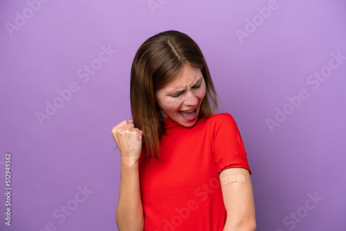 Young English woman wearing band-aids isolated on purple background celebrating a victory