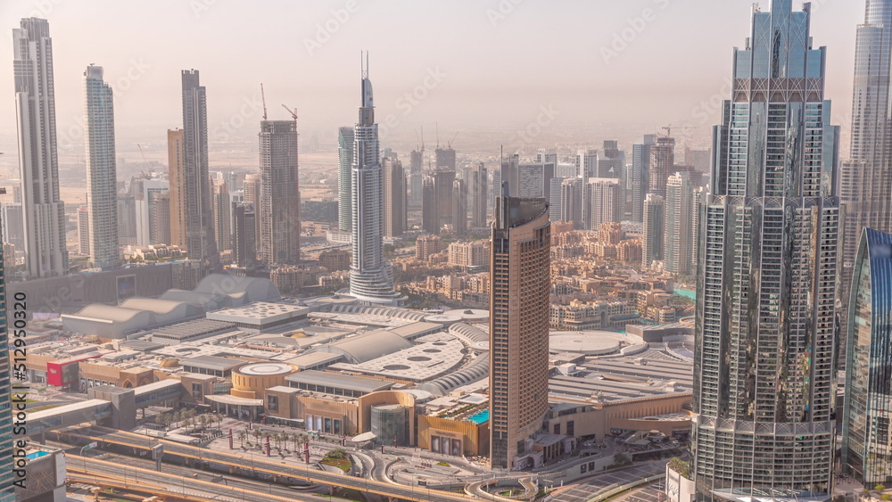 Aerial view of tallest towers in Dubai Downtown skyline and highway timelapse.