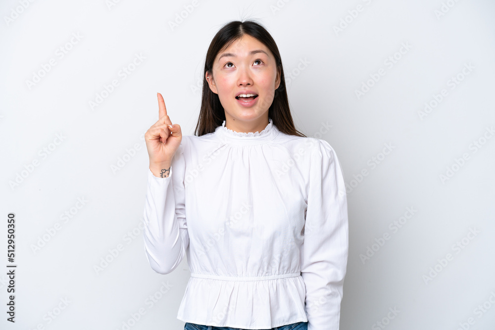 Young Chinese woman isolated on white background pointing up and surprised Young Chinese woman isolated on white background pointing up and surprised