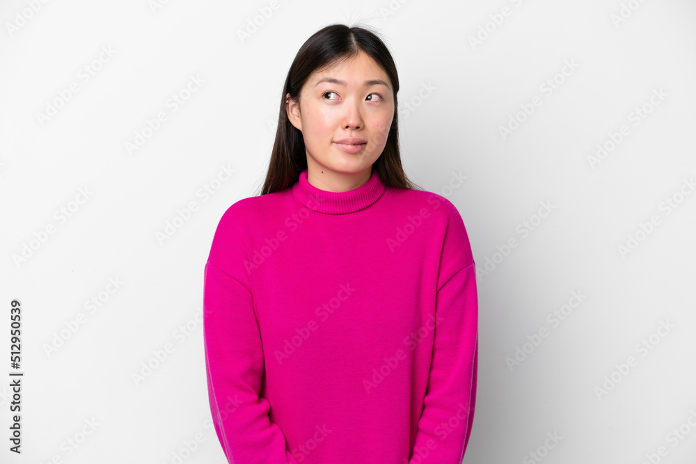 Young Chinese woman isolated on white background having doubts while looking up Young Chinese woman isolated on white background having doubts while looking up