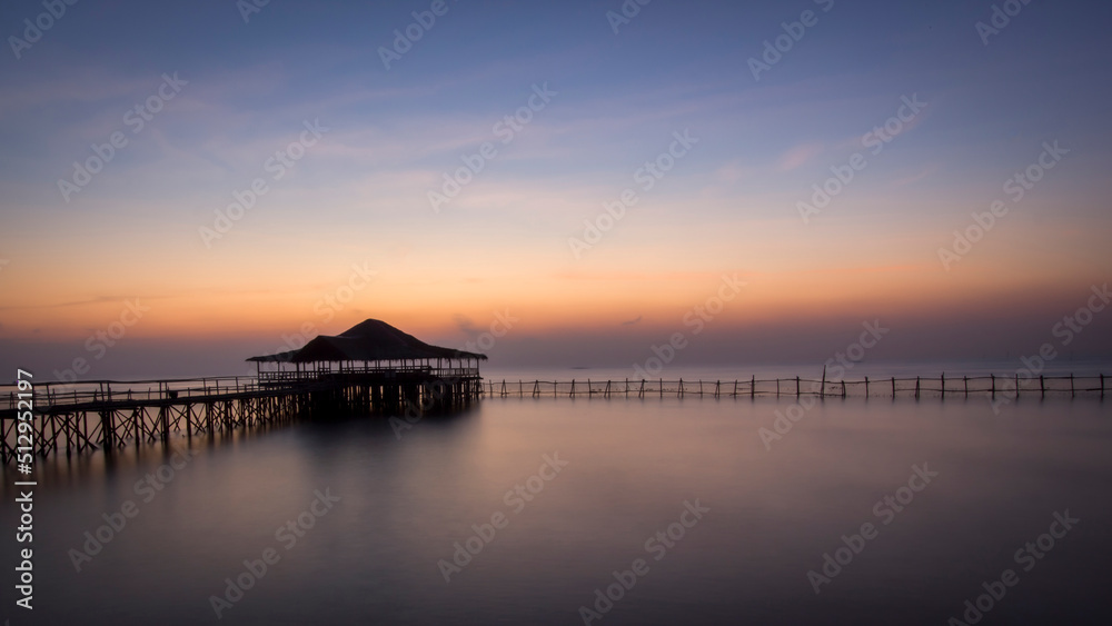 Sunrise on the beach of East Surabaya, Indonesia with traditional house called joglo