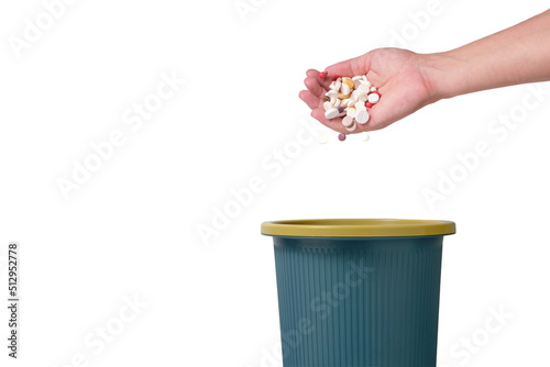 Throwing large number pills in trash.Isolated on white background.