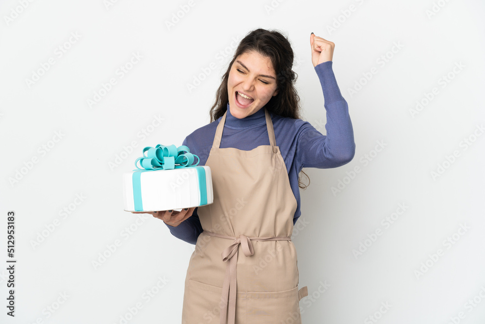 Pastry Russian chef holding a big cake isolated on white background celebrating a victory Pastry Russian chef holding a big cake isolated on white background celebrating a victory