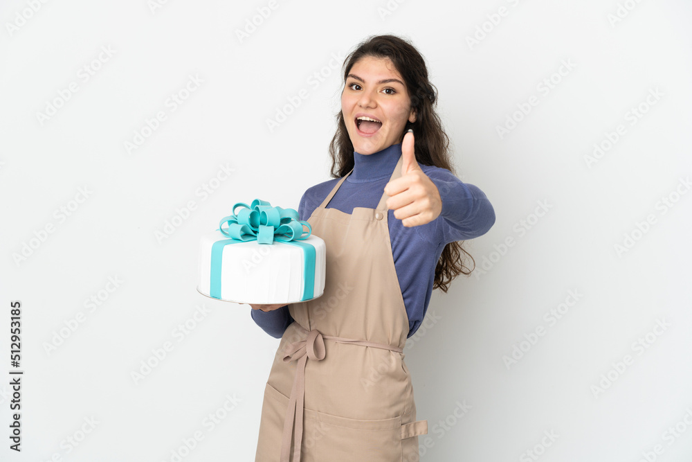 Pastry Russian chef holding a big cake isolated on white background with thumbs up because something good has happened Pastry Russian chef holding a big cake isolated on white background with thumbs up because something good has happened