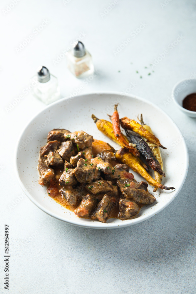 Homemade meat ragout with roasted carrots Homemade meat ragout with roasted carrots