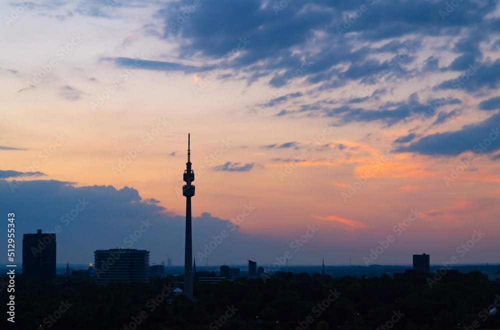 Skyline panorama of Dortmund Germany with TV-Tower and city centre skyline after colorful Sunset summer. Blue hour twilight with silhouettes of buildings, factories and power plants on the horizon.