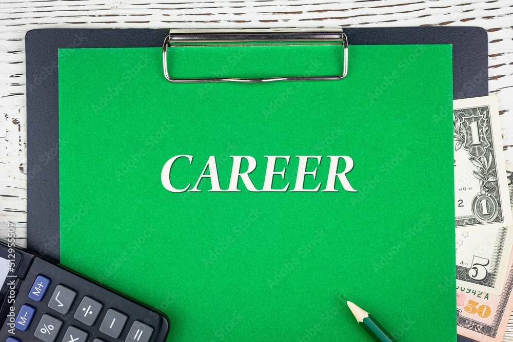 Obraz premium CAREER - word (text) dollar bills on green background, pencil, calculator and wooden white table. Business concept: buying, selling, commerce (copy space).