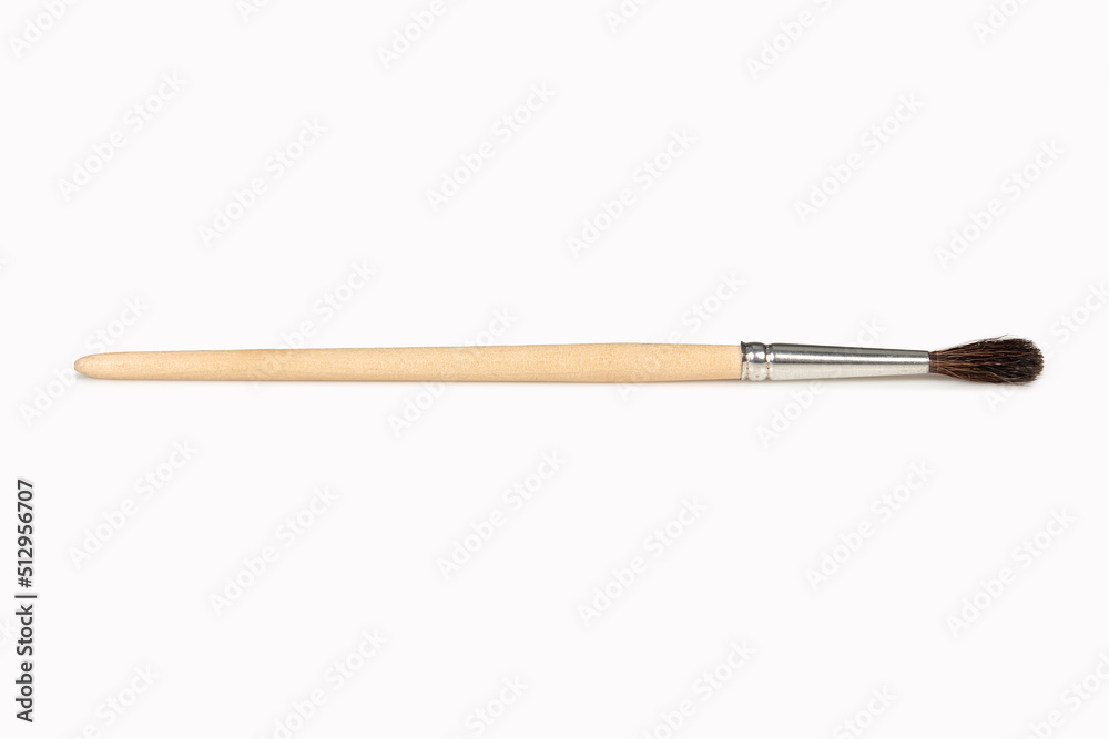 Paintbrush with wooden handle isolated on white background