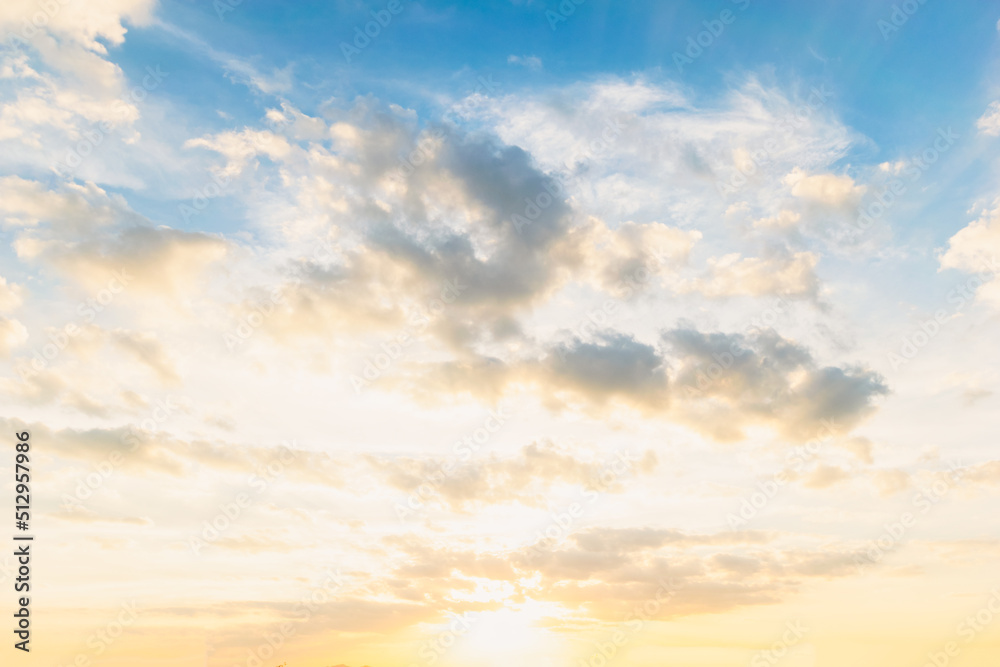 Obraz premium Sky blue and orange light of the sun through the clouds in the sky