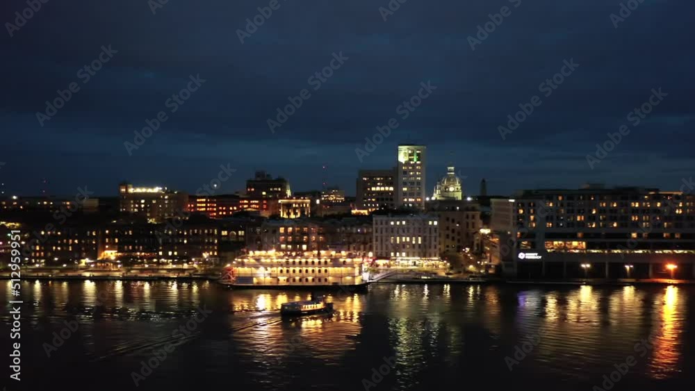 Night Scene Over Savannah River In Georgia With View Of Historic Waterfront. aerial sideways Night Scene Over Savannah River In Georgia With View Of Historic Waterfront. aerial sideways