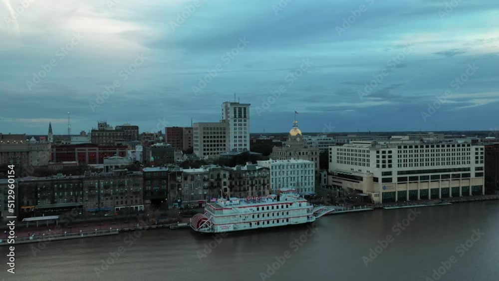 Riverboat Cruise At Savannah River With Waterfront And City Hall Building In Savannah, Georgia, USA. - aerial forward Riverboat Cruise At Savannah River With Waterfront And City Hall Building In Savannah, Georgia, USA. - aerial forward