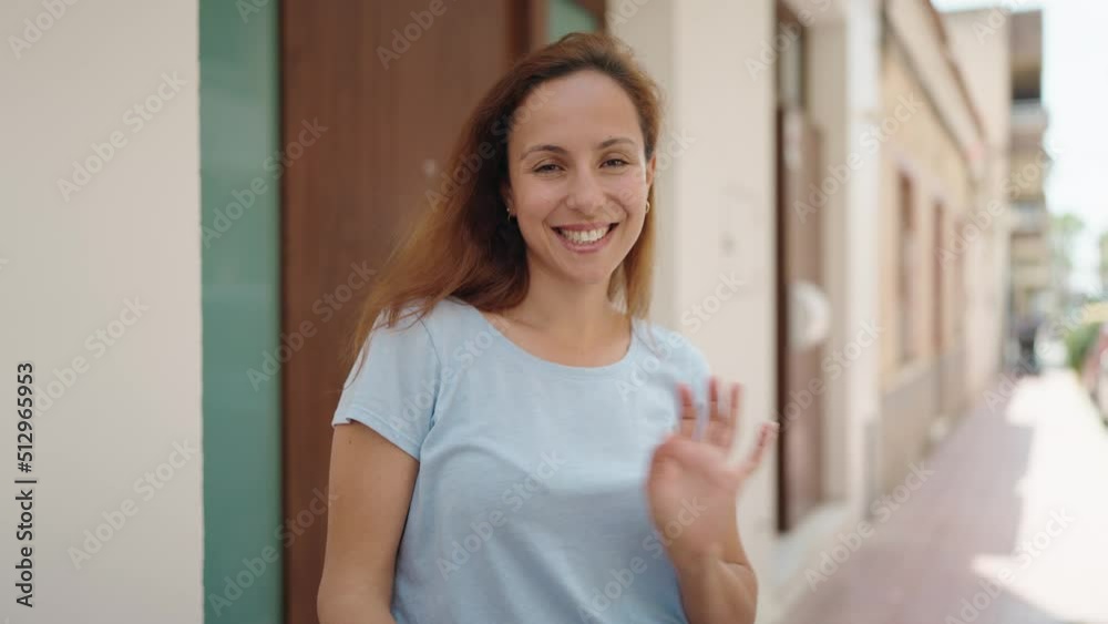 Young woman smiling confident standing with arms crossed gesture at street Young woman smiling confident standing with arms crossed gesture at street