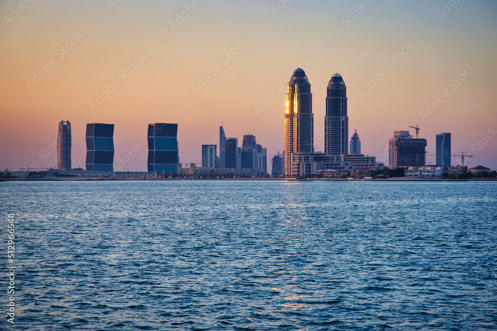 Fototapeta premium Doha city skyline from the water at sunset